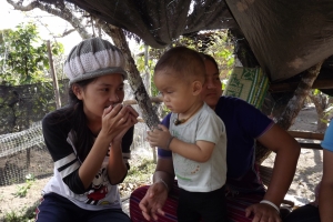 Som Rudee, Tasanee's sister plays with her nephew. Som Rudee is studying English and Tourism at Chiang Mai College. 
